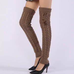 Detail view of coffee brown cable knit over-knee leg warmers with fuzzy pom-poms and drawstring