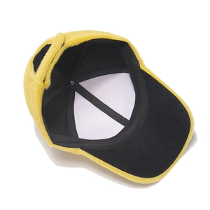 Detail view of the soft yellow faux fur exterior and black fabric lining of the baseball cap