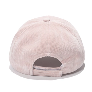 Detail of light pink corduroy baseball cap showing textured fabric and velcro strap