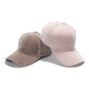 Detailed texture of ribbed faux mink baseball cap in soft pink and taupe shades