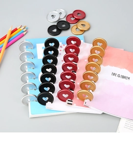 Close-up of 35mm colorful heart-shaped discbound discs for loose-leaf notebook binding