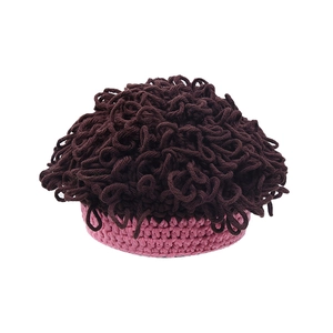 Detailed knit texture of children's wig hat with brown curly yarn and pink headband