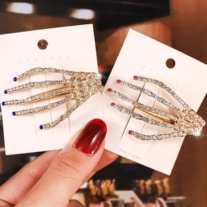 Skeleton hand hair clips with sparkling rhinestones in gold metal finish for women