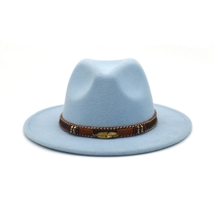 Detail view of light blue fedora hat with ethnic woven band and golden feather pendant