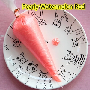 Close-up of pearlescent watermelon red cream glue in a piping bag for DIY phone cases