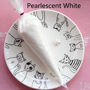 Close-up of pearlescent white DIY cream glue in a piping bag for handmade crafts