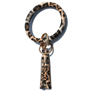 Detail of leopard print leather keychain bracelet with gold metal ring and tassel