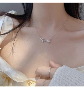 Close-up of elegant flower opal necklace with diamond petals on woman's neck