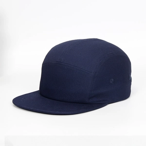 Detail of navy blue five-panel cotton camping cap with flat brim and stitched seams