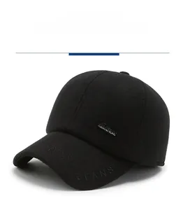 Detail of black wool baseball cap with JEANS metal tag and textured embroidery