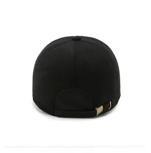 Detail view of the back of a black wool winter baseball cap with metal buckle strap