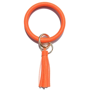 Orange lychee grain leather keychain bracelet with golden spring clasp and tassel detail