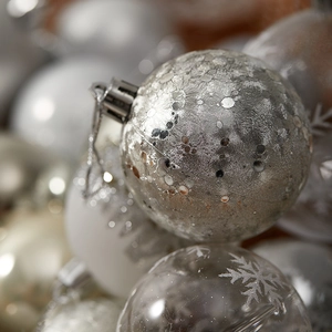 Silver painted Christmas ball ornaments with snowflake patterns for festive holiday decor