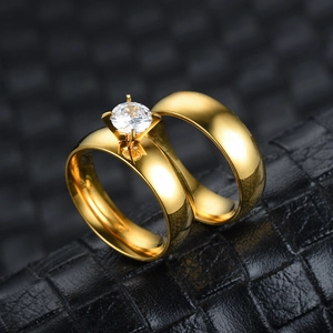 Macro shot of 18K gold plated stainless steel couple rings with a sparkling zircon inlay