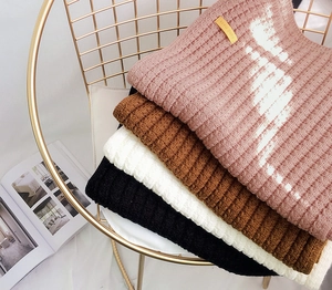 Detailed texture of thick knit scarves in pink, brown, white and black colors