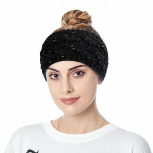 Close-up of black knitted headband with colorful speckled yarn and elastic texture