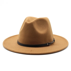 Detail of camel wool fedora hat featuring flat wide brim and black leather band with silver buckle
