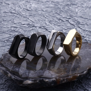 Set of four geometric stainless steel rings in black, silver, and gold for hip-hop style