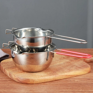 Stack of 304 stainless steel chocolate melting pots with red silicone handle on wood
