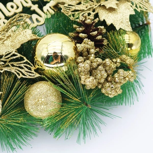 Macro detail of Christmas wreath with gold baubles, pine cones, and green needles