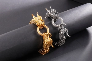 Detailed close-up of double dragon head bracelets in gold and silver stainless steel finish
