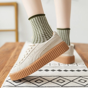 Beige suede platform creepers with thick rubber soles and green plaid crew socks