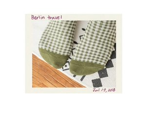 Detail of green plaid cotton socks featuring a solid color toe and knit texture