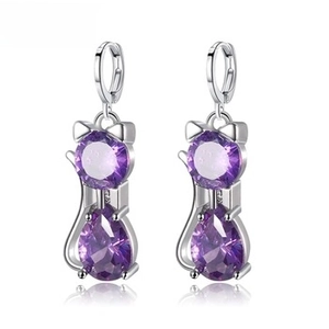 Detail of silver cat earrings featuring round and teardrop-shaped purple zircons