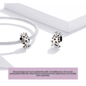 Detail view of S925 sterling silver giraffe charm with brown enamel on a mesh bracelet