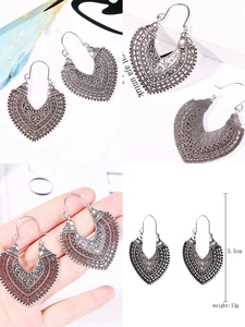 Detail of bohemian heart-shaped carved earrings in antique silver finish with dimensions