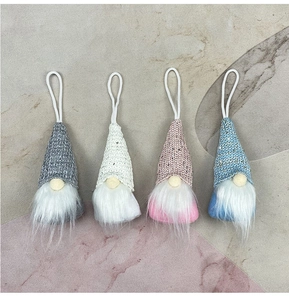 Detailed view of four colorful handmade gnome ornaments with knitted hats and plush beards