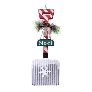 Christmas wooden shovel wall hanging with Noel sign, pine cones and faux snow decor