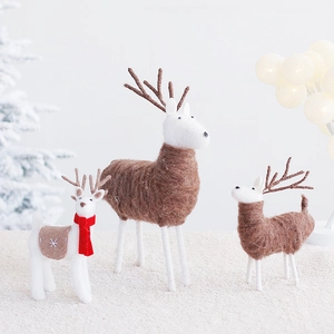 Three handmade wool felt Christmas reindeer ornaments with red scarves for holiday home decor