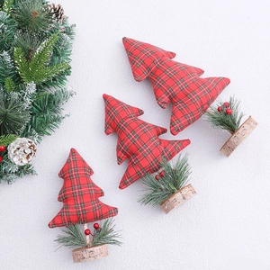 Three sizes of red plaid mini Christmas trees with rustic wood bases for desk decor