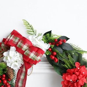 Lush Christmas wreath with red plaid ribbons, berries, pinecones and faux greenery decor
