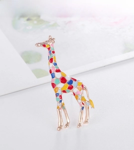 Close-up of vibrant enamel giraffe brooch with rose gold plating and colorful patterns