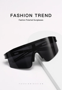 Detail shot of black semi-rimless polarized shield sunglasses on a white display pedestal