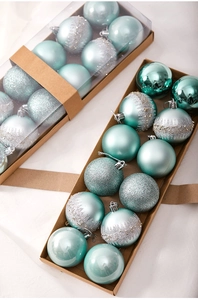 Detailed view of teal and silver Christmas ornaments with glitter and matte finishes