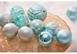 Close-up of mint and blue Christmas balls with matte, glitter and wave textures
