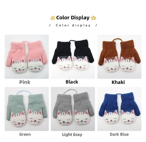 Detailed color display of kids knitted mittens with cartoon cat patterns and lanyards