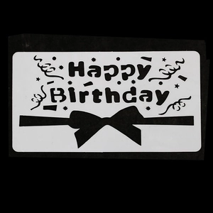 Close-up of Happy Birthday hollow stencil with bow and star patterns for DIY decorating