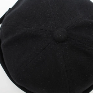 Detail view of cotton docker hat crown with stitched panels and matching top button