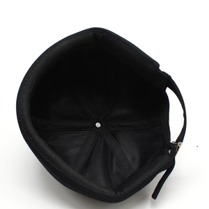 Detailed interior of a black cotton miki hat showing six-panel stitching and metal buckle