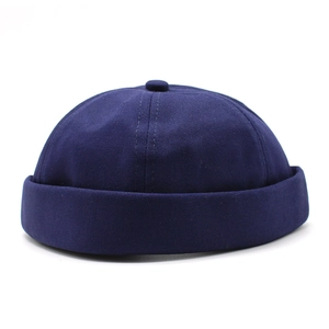 Close-up of navy blue cotton docker hat with dome top and rolled cuff detail