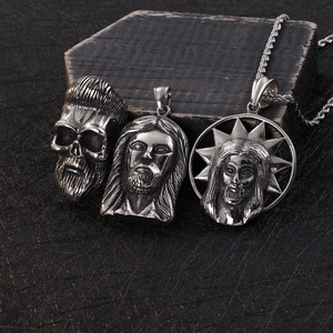 Set of 3 stainless steel skull and Jesus pendants with silver finish on dark background