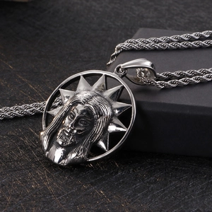 Detail of silver skull relief pendant with twisted rope chain on jewelry box