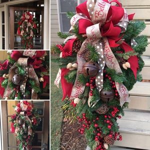 Christmas teardrop swag with red berries, pine cones and rustic metal bells for home decor