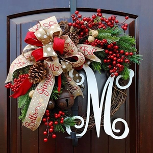 60cm Christmas teardrop wreath with letter M, red berries, and Jingle Bells ribbon on wood door