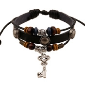 Detail of multi-layer leather bracelet with blue beads and vintage silver key charm