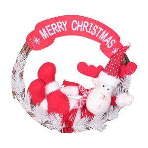 Christmas wreath with plush reindeer and Merry Christmas sign on natural rattan base